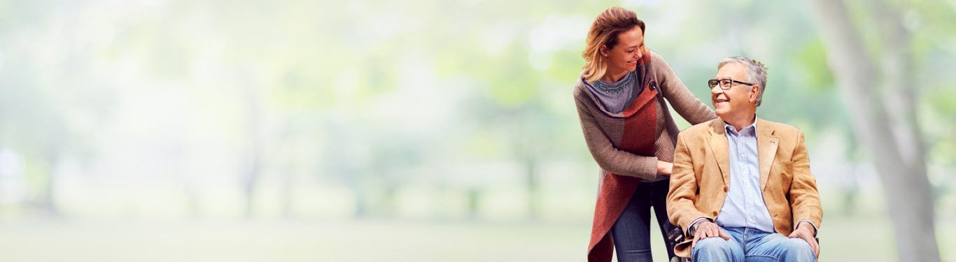 Caregiver walking with a senior client outdoors