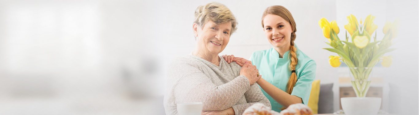 Caregiver holding hands with a senior client