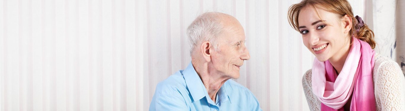 Caregiver sharing a conversation with a senior veteran